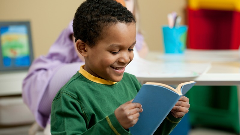 Child happy reading a book